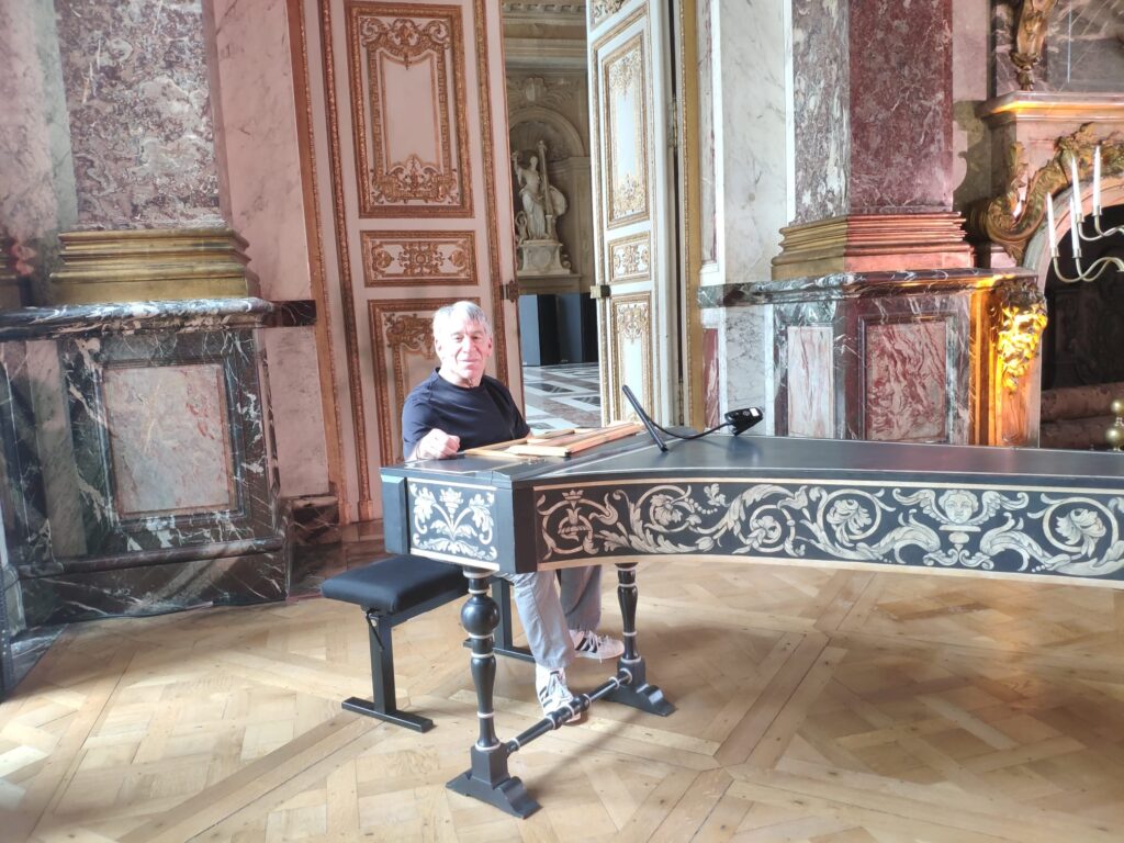 Composer Stephen Schwartz plays a piano at Versailles
